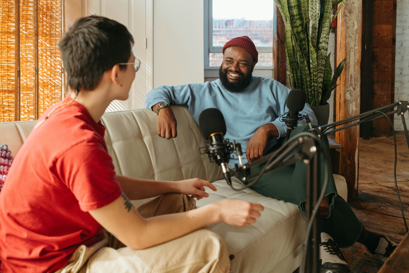 Podcast interview on a sofa, two mics